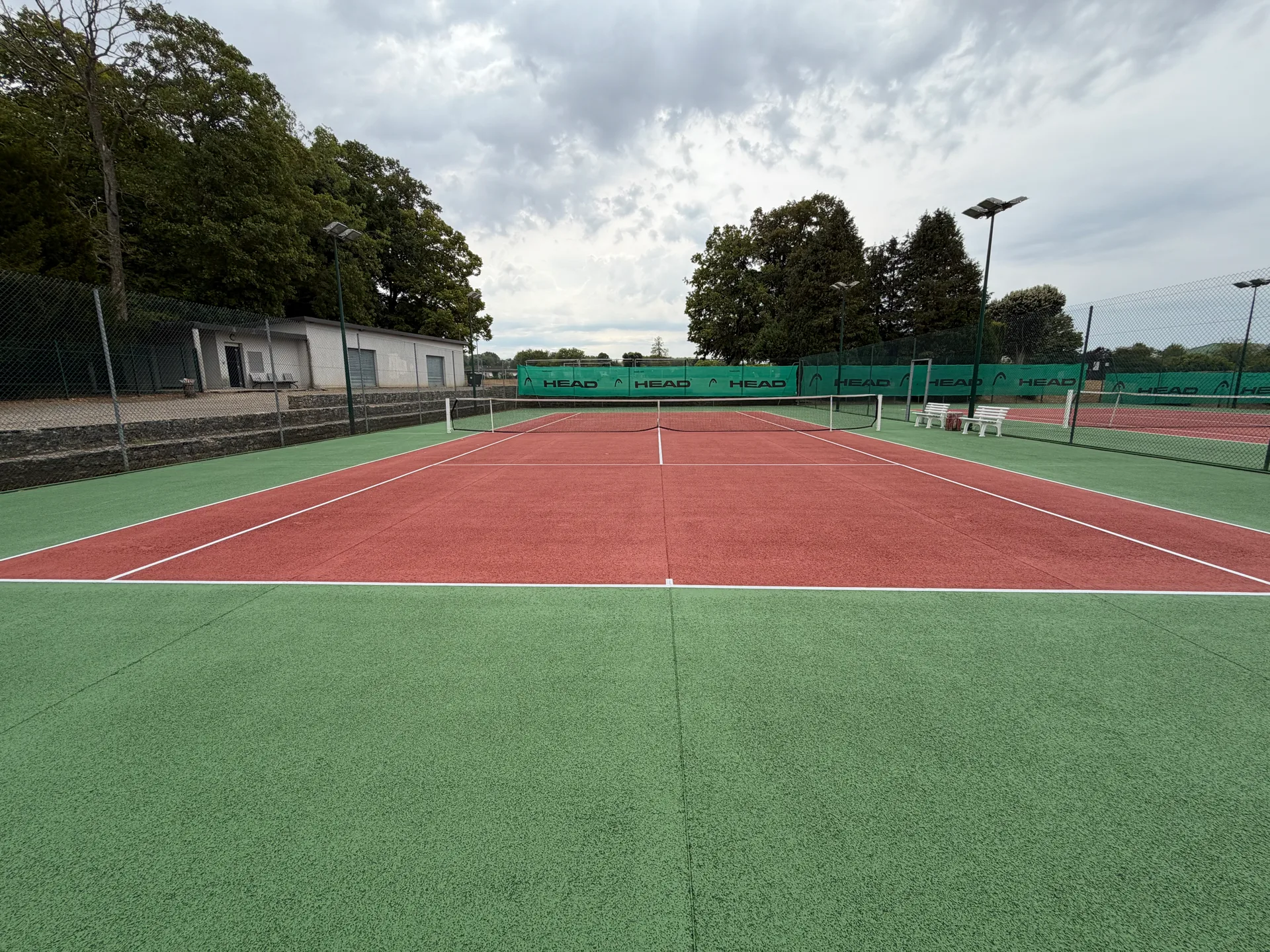 Les courts de tennis extérieurs en béton poreux vert et rouge, au stade municipal Paul Chéron